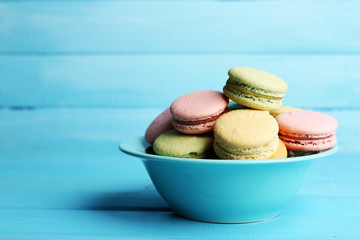 Assortment of gentle colorful macaroons in colorful bowl