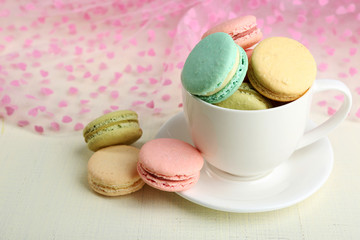 Assortment of gentle colorful macaroons in colorful mug