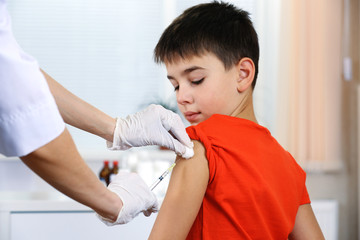Boy and vaccine syringe