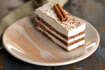Tasty tiramisu cake on plate, close up