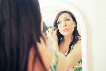 Young girl putting make-up