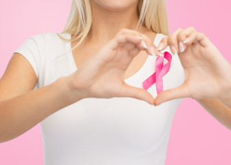 close up of woman and pink cancer awareness ribbon