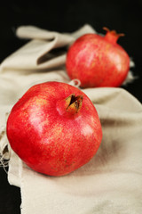 Juicy ripe pomegranates on tablecloth