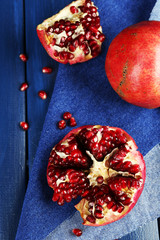 Juicy ripe pomegranates on wooden table