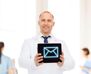 smiling male doctor with tablet pc