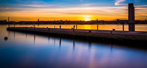 Long exposure of a pier at sunset, in Fells Point, Baltimore, Ma