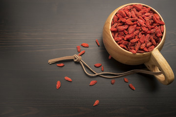Goji berries in a wooden bowl on the table