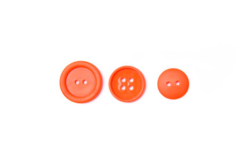 Orange plastic buttons with pins on White Isolate Background