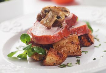 Slices of roasted ham with mushrooms