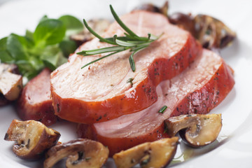 Slices of roasted ham with mushrooms