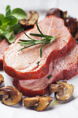 Slices of roasted ham with mushrooms