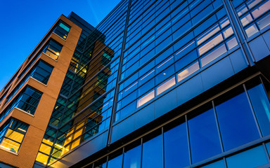 Fototapeta na wymiar Modern glass building at twilight, in Baltimore, Maryland.
