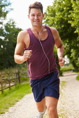 Man Running In Countryside Wearing Earphones