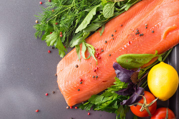 Salmon woth seasoning on a pan