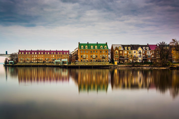 Reflections of waterfront buildings along the Potomac River in A