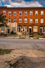 Row houses and cracked sidewalk in Baltimore, Maryland.