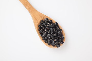 Black beans with wooden spoon