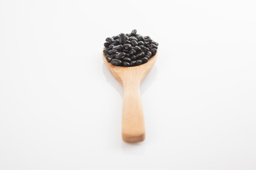 Black beans with wooden spoon