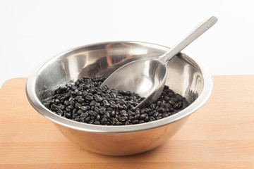 Black beans in bowl with transfer scoop