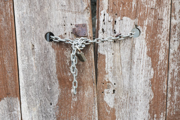 Old wooden door with a locked door