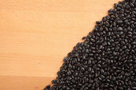 Black beans on wood table