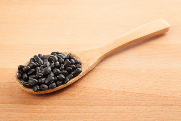 Black beans with wooden spoon