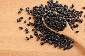 Black beans with wooden spoon