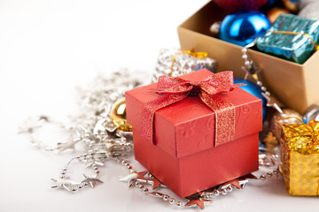 Red gift box with christmas tree bauble and ornament