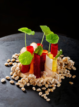 Fine dining appetizer, vegetable on barley with sauce