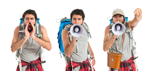 Backpacker shouting by megaphone over white background