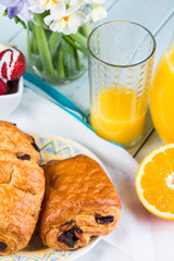 Chocolate croissant with orange juice