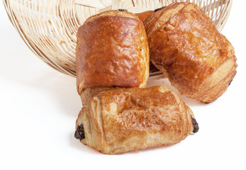 Pains au chocolat dans une corbeille sur fond blanc