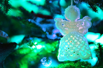 Knitted Christmas angel on Christmas lights background