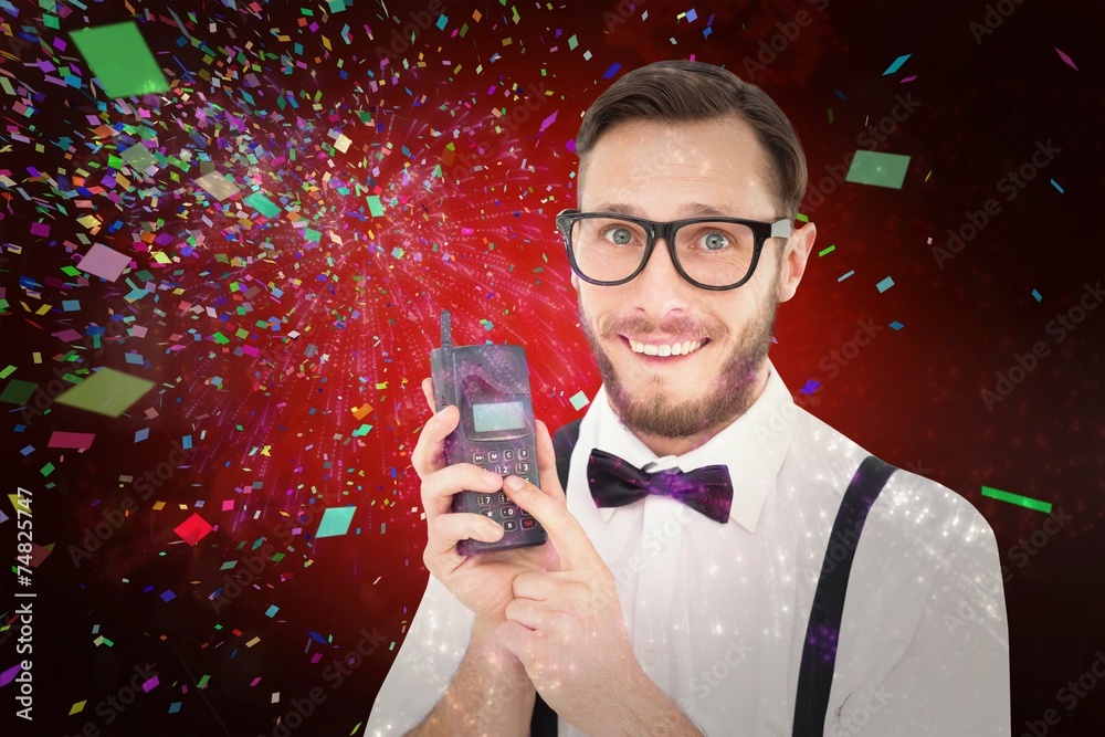 Aufkleber composite image of geeky hipster holding a retro cellphone
