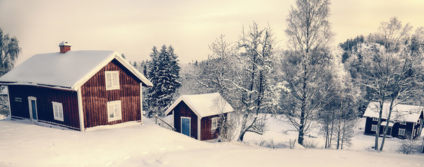 old rural cottages in a snowy winter landscape, Sweden