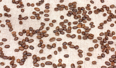 Fresh coffee beans on wood and linen bag