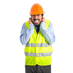 Workman covering his ears