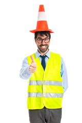 Workman with thumb up with traffic cone like hat