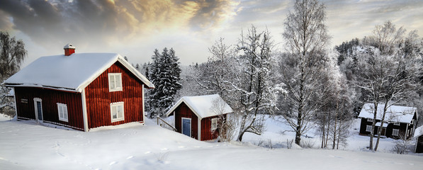 old rural cottages in a snowy winter landscape, panoramic view