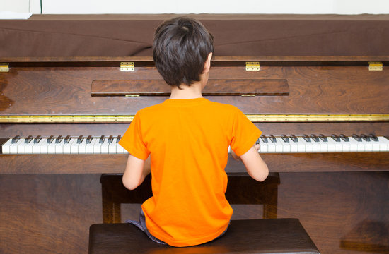 little boy playing piano