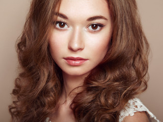 Fototapeta premium Portrait of young beautiful girl with curly hair