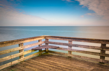 Fototapeta na wymiar Long exposure a pier and the Chesapeake Bay in Chesapeake Beach,