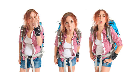 Fototapeta premium backpacker doing a joke over isolated white background