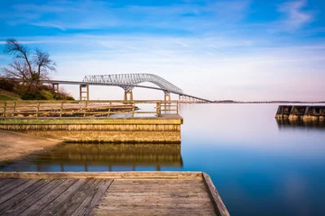 Zelfklevend Fotobehang Long exposure of piers in the Patapsco River and the Francis Sco © jonbilous