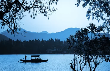 Plexiglas foto achterwand Chinese wooden recreation boat floats on the still water © evannovostro