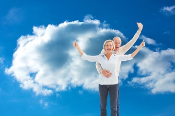 Composite image of happy mature couple cheering at camera
