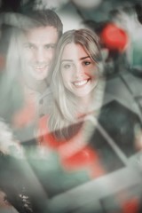 Composite image of happy couple holding each other