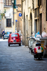 Narrow Alley With Old Buildings In Typical Italian Town