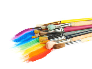 Pile of different brushes over the paint strokes