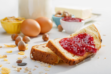 Healthy breakfast. Two slices of bread with jam on wooden table.